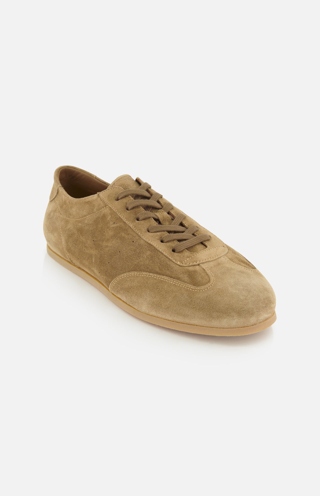 Showcased at an angle against a white background, the COMMON PROJECTS Winter Suede Driving Sneaker features tan suede, brown laces, and a rubber sole—offering luxury low-top design that merges timeless style with casual elegance.