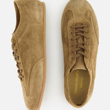 The COMMON PROJECTS Winter Suede Driving Sneaker is a luxurious low-top shoe crafted from tan suede, detailed with brown laces and elegant gold branding inside. Shown from both the side and top view, these sneakers feature distinctive gum soles and combine timeless style with modern sophistication.