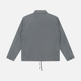 The C.P. COMPANY Cotton Rip-Stop Overshirt is shown from the back, with a straight hem, adjustable drawstring, and buttoned cuffs. Made from 100% cotton, it blends minimal style with subtle utilitarian details.