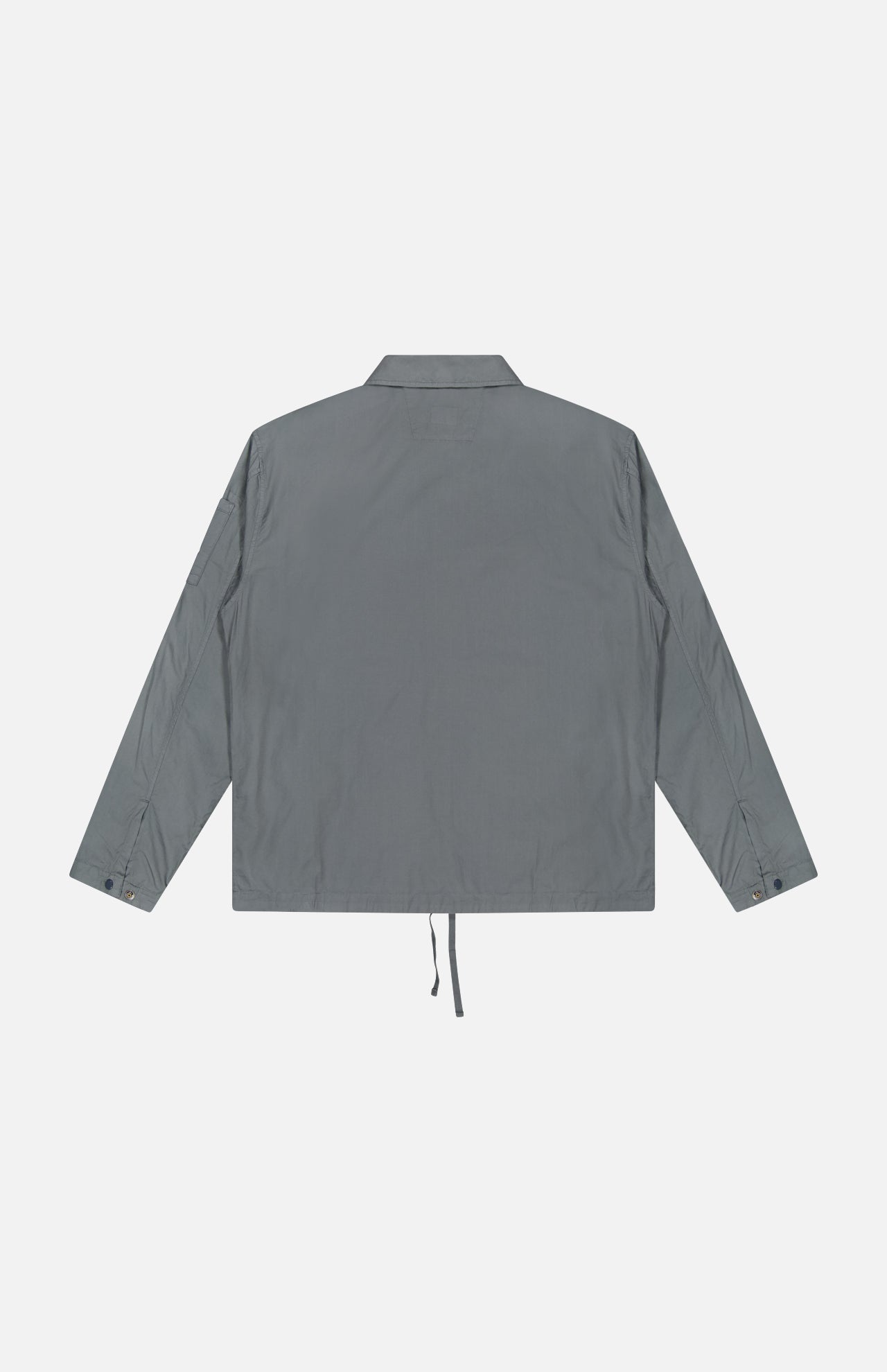The C.P. COMPANY Cotton Rip-Stop Overshirt is shown from the back, with a straight hem, adjustable drawstring, and buttoned cuffs. Made from 100% cotton, it blends minimal style with subtle utilitarian details.