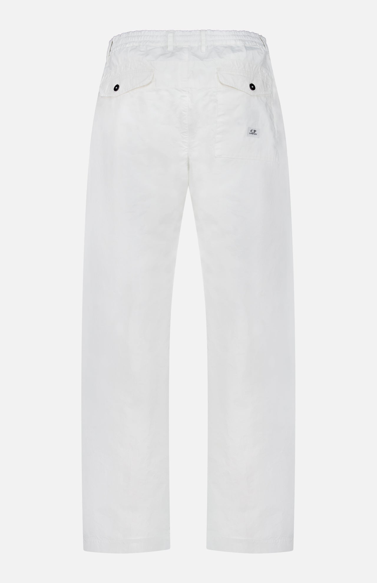 Back view of C.P. COMPANY Micro-Reps Boxy Loose Pants in white, made from high-density cotton with elastic and drawstring waistband, two buttoned back pockets, and a small tag label above the right pocket.