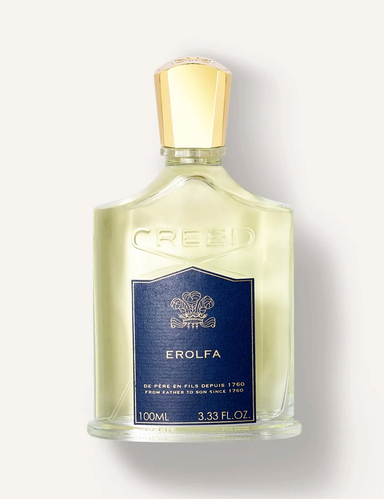 A clear glass bottle of CREED Erolfa 100ml, a fresh aromatic fragrance with Mediterranean notes, features a gold cap and a dark blue label showing the CREED brand, Erolfa name, and the 100ml (3.33 fl. oz) size.