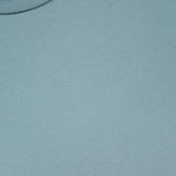 Close-up of the Hunt Cotton Short Sleeve Crew T-shirt by CROSSLEY in light blue, laid flat to show the upper chest and neckline. The white tag displays CROSSLEY and MADE IN ITALY, highlighting its quality Italian craftsmanship.