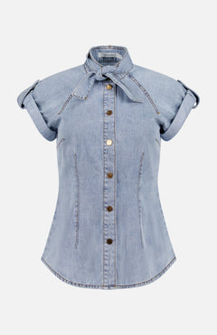 The ZIMMERMANN Denim Tie Neck Shirt is a slim fit, light blue denim blouse with short sleeves, rolled cuffs, and a removable necktie detail, shown on a plain white background.