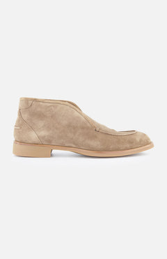 The DI BIANCO Fidenza Suede Farro Boot is shown in side profile, highlighting its minimalist tan suede design with a low heel and rounded toe, set against a plain white background.