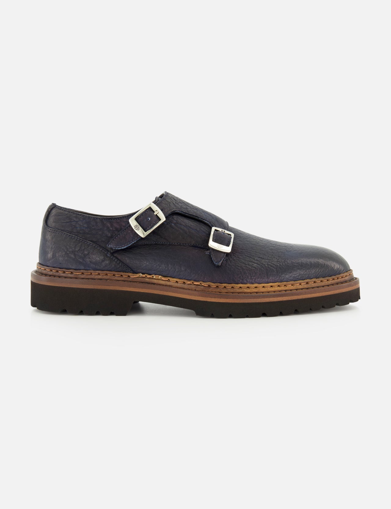 The Mezzaro Bisonte Loafer by DI BIANCO features dark blue bison leather with double monk straps, two silver buckles, a brown midsole, and a black rubber outsole, displayed in profile against a plain white background.