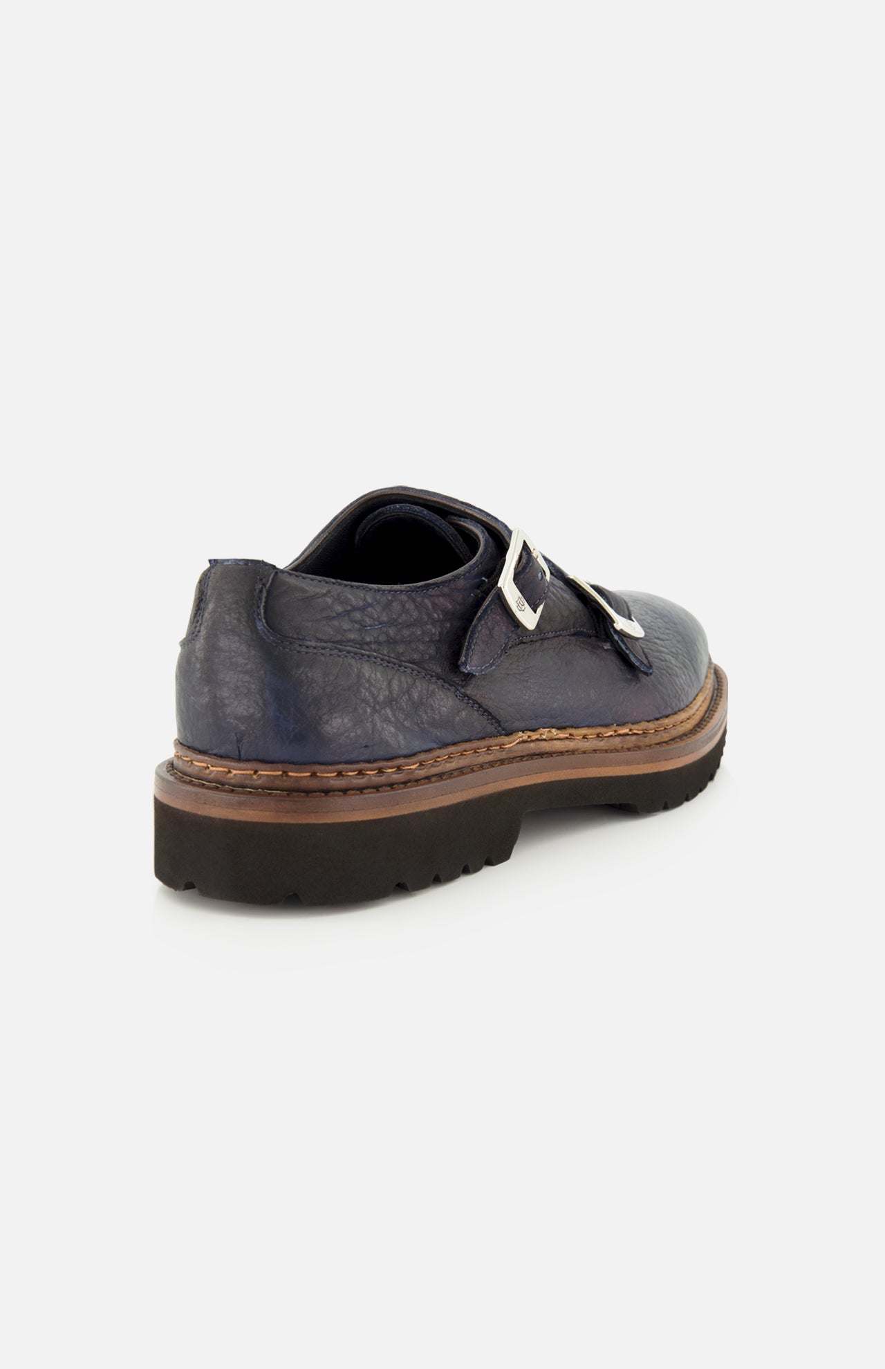 The Mezzaro Bisonte Loafer by DI BIANCO is a dark blue bison leather double monk dress shoe featuring two silver buckles and a thick brown sole, displayed from a rear-side angle against a plain white background.