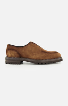 DI BIANCO’s Marche Suede Loafer in light brown features hand-stitched detailing, visible stitching, a lace-up design, and a thick dark rubber sole, shown in profile on a plain white background.
