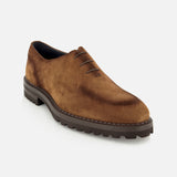 The Marche Suede Loafer by DI BIANCO is a light brown suede lace-up dress shoe featuring a chunky dark rubber sole and exquisite hand-stitching for exceptional quality and craftsmanship, shown at an angle against a plain white background.