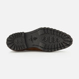 The image displays the black rubber sole of the DI BIANCO Marche Suede Loafer, featuring rugged, textured treads and a central logo. The number 9 and brand markings near the heel emphasize that this light brown suede loafer exemplifies expert craftsmanship typically found in hand-stitched shoes made in Italy.