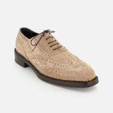 The DI BIANCO Nettuno Suede Lace Up Loafer in beige features decorative perforations, dark brown laces, and a dark brown sole with Norwegian welting, shown against a white background.