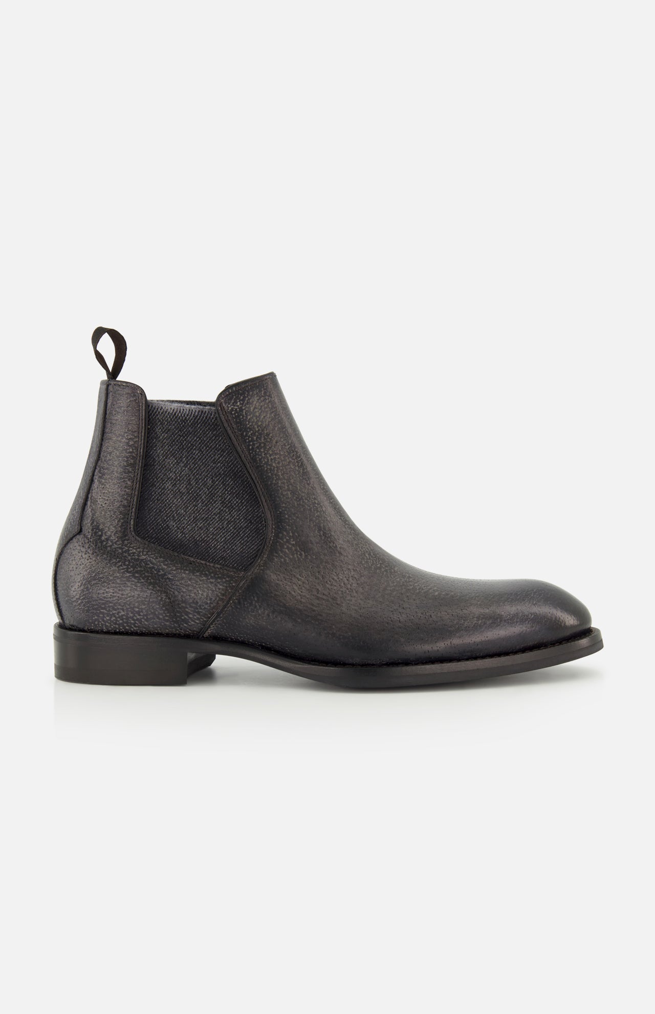 The Osimo Peccary Boot by DI BIANCO is a black leather Chelsea boot featuring elastic side panels, a pull tab, low stacked heel, and rounded toe, shown in a side profile on a plain white background.