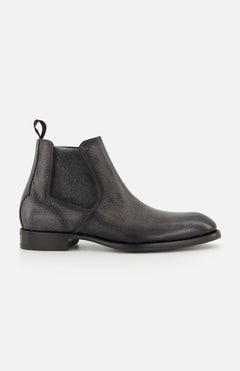 The Osimo Peccary Boot by DI BIANCO is a black leather Chelsea boot featuring elastic side panels, a pull tab, low stacked heel, and rounded toe, shown in a side profile on a plain white background.