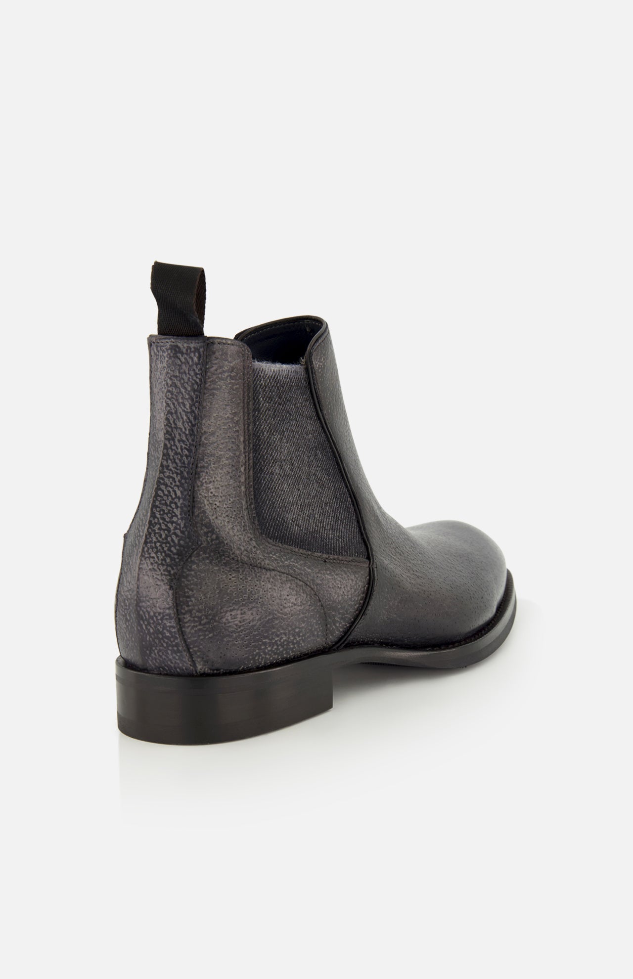 The Osimo Peccary Boot by DI BIANCO is shown from the back left, highlighting its black grained leather, heel, sole, and pull tab against a plain white background.