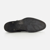 The image displays the black sole of the Osimo Peccary Boot by DI BIANCO, crafted from grained leather. Viewed from below on a white background, it features a stamped logo near the heel and has a smooth, minimal tread.