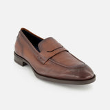 The DI BIANCO Tombolo California Slip On Loafer, a brown leather shoe with a penny strap, low heel, and rounded toe, made in Italy, is shown on a plain white background.