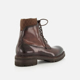 Introducing the DI BIANCO Torino Calfskin Suede Boot: a luxurious handmade Italian boot in dark brown suede, featuring a sturdy thick sole and a quilted fabric collar at the ankle. Displayed from a rear side angle against a white background.