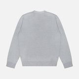 The ELDER STATESMAN Libeccio Wren Crewneck Sweater, in a plain light gray luxury knitwear fabric, is laid flat with the back facing up to showcase its crew neckline along with ribbed cuffs and hem, set against a white background.