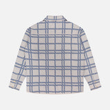 The Nimbus Plaid Button Up Knit Overshirt from ELDER STATESMAN is a long-sleeve, collared shirt with a white base and blue checkered pattern, displayed from the back against a plain white background.