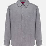 The ELDER STATESMAN Pashmina Big Button Up Shirt is a long-sleeve, light grey shirt featuring a front chest pocket and designed for versatile office wear, shown on a plain white background.
