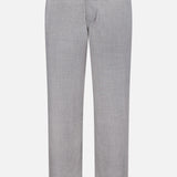 The Pashmina Norm Pant by ELDER STATESMAN is crafted from a smooth, light gray fabric. These men’s dress pants feature belt loops, a front button and zipper closure, and a classic straight-leg cut, shown against a white background.