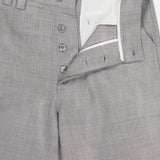 The Pashmina Norm Pant by ELDER STATESMAN is crafted from light gray wool-cashmere with a fine, smooth texture for an elegant look. These men's dress pants feature a partially open button fly that reveals a white inner lining, as well as a waistband with belt loops and a pink label sewn inside.