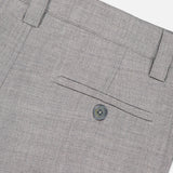 The ELDER STATESMAN Pashmina Norm Pant in gray wool cashmere is shown in close-up, highlighting a buttoned back pocket, belt loops, and intricate stitching details against a light background.