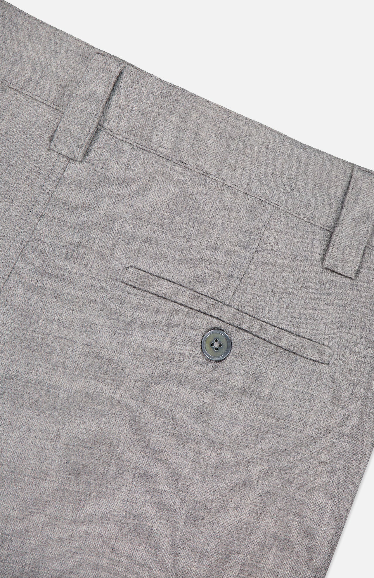 The ELDER STATESMAN Pashmina Norm Pant in gray wool cashmere is shown in close-up, highlighting a buttoned back pocket, belt loops, and intricate stitching details against a light background.