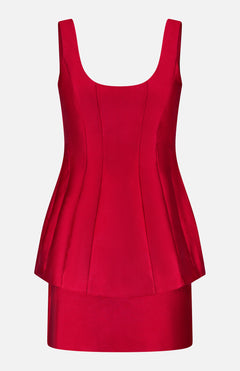 The Empire Peplum Waist Dress by AMANDA UPRICHARD is a sleeveless, fitted scarlet mini dress with a scoop neckline, corset-style seams, and a flared peplum waist, shown on a plain white background.