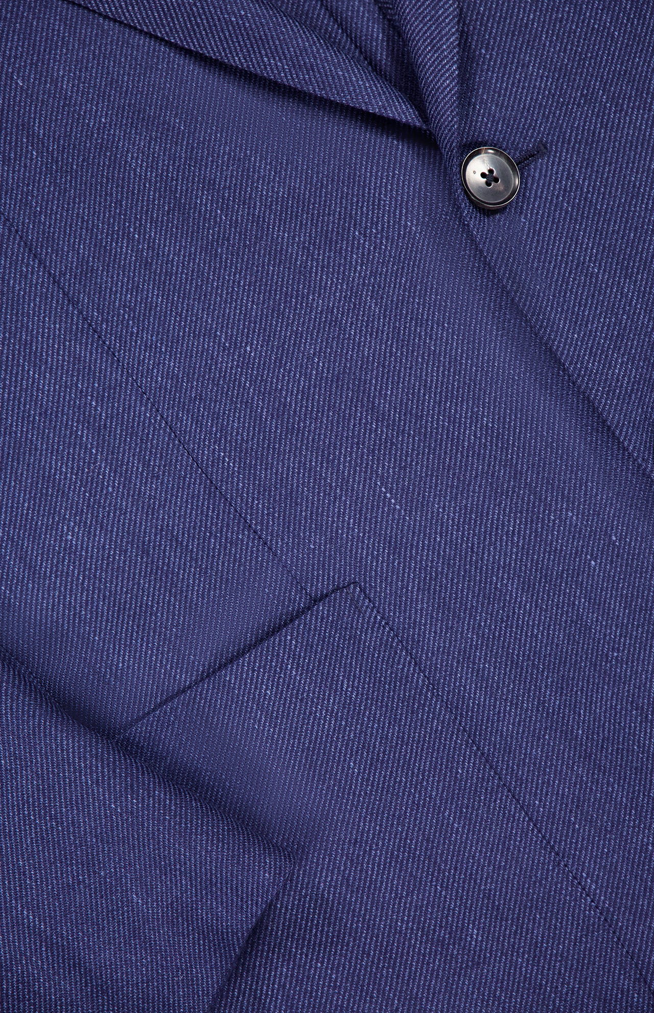 Close-up of the ZEGNA Cashmere Silk Linen Sportcoat in dark blue, made in Italy. The image highlights the lapel, a single black button, part of a pocket, and displays the fabric’s fine stripes and textured weave.