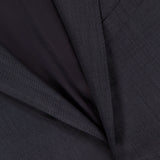 Close-up of the ZEGNA 15MilMil15 Wool Suit in dark grey, made in Italy, highlighting the lapel, chest pocket, button, and part of the inner lining.