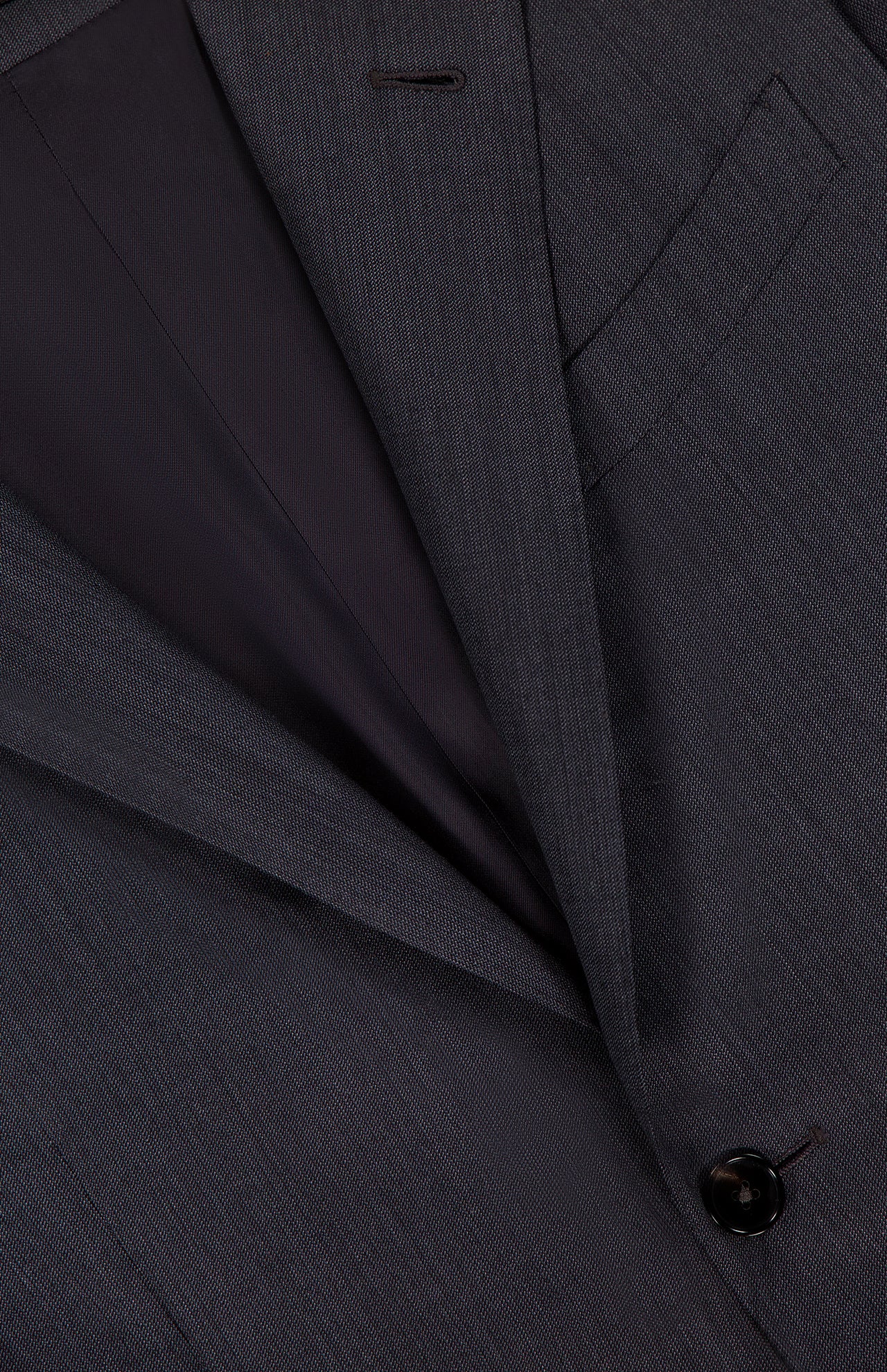 Close-up of the ZEGNA 15MilMil15 Wool Suit in dark grey, made in Italy, highlighting the lapel, chest pocket, button, and part of the inner lining.