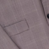 Close-up of the ZEGNA 15MilMil15 Wool Suit in light brown, made in Italy, featuring a button, sleeve detail, and flap pocket with a fine plaid texture on premium wool fabric.