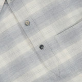 A close-up of a ZEGNA Cashco Flannel Shirt showcasing a light gray and white plaid pattern, partial button placket, and chest pocket.
