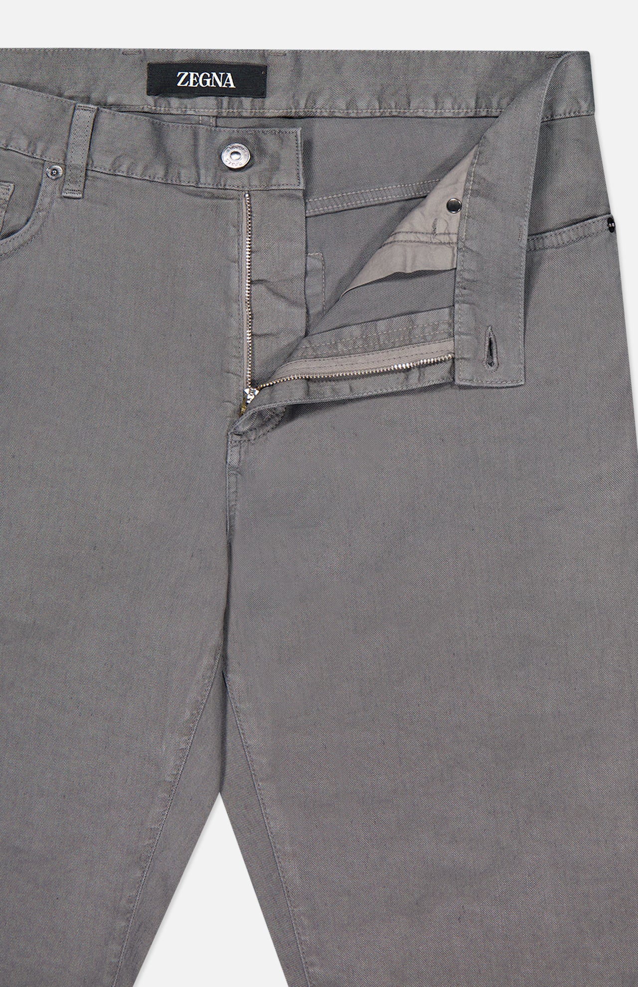 The ZEGNA Comfort Linen Cotton Pants are shown in grey with the fly open, displaying the smooth fabric, zipper, partial inner lining, and a waistband accented by a ZEGNA label.