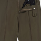Olive green Cotton & Wool Trouser Pants by ZEGNA, featuring a partially open zipper, button, and hook closure that reveals the black inner waistband and tag. The smooth, expertly crafted fabric gives these tailored pants a modern spin on classic cotton wool tailoring.