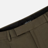 Close-up of the ZEGNA Cotton & Wool Trouser Pants in olive green, featuring the waistband, belt loops, and a partial view of a black interior label with white text. The fabric displays a smooth yet subtly textured finish, emphasizing the quality craftsmanship of these dark green trousers.