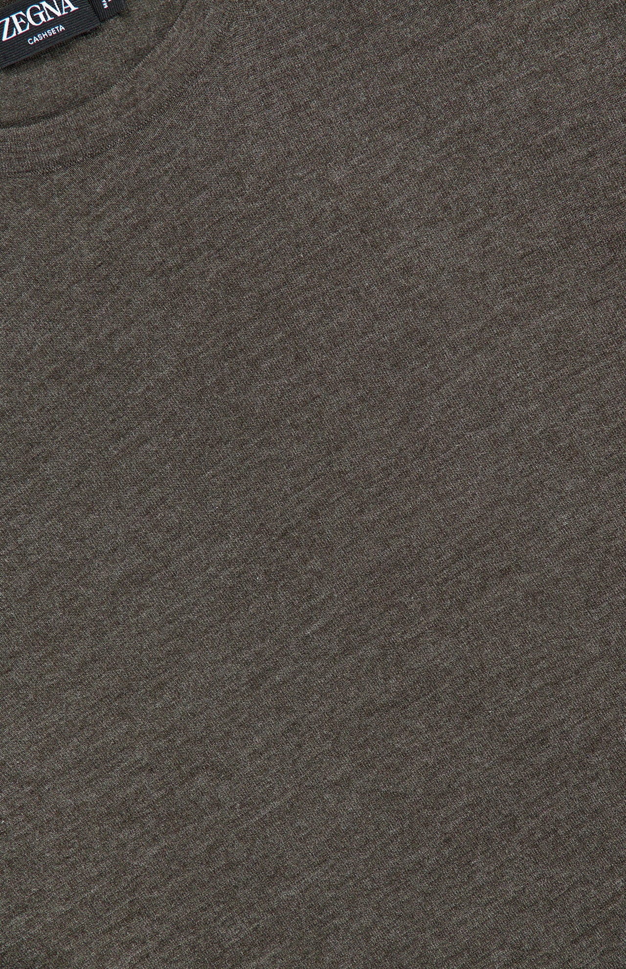 Close-up of a brown Crewneck Long Sleeve Shirt crafted from luxurious cashmere, showcasing its soft texture and exquisite craftsmanship. The ZEGNA brand label, partially visible at the neckline in the upper left corner of the image, subtly alludes to its distinguished “made in Italy” heritage.