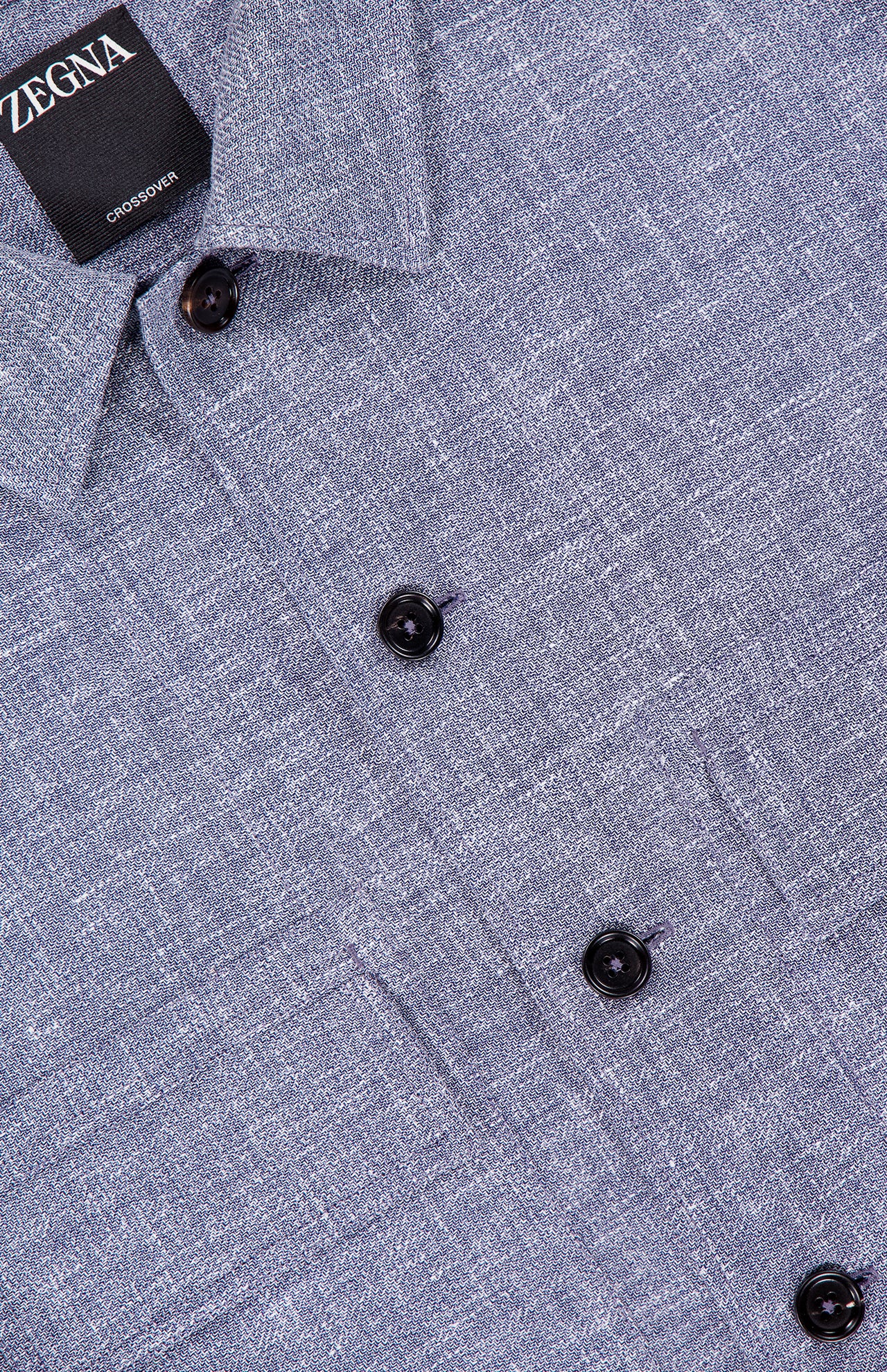 Close-up of the ZEGNA Crossover Linen-blend Overshirt in grey, featuring lightweight crossover fabric, black buttons, and a visible ZEGNA label near the collar. Made in Italy.