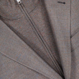 Close-up of the ZEGNA Detachable Knit Bib Sportcoat, featuring a brown men's luxury blazer layered over a matching zip-up knit bib, with highlighted zipper and lapel details.