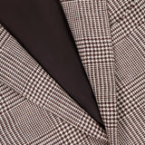 Close-up of the ZEGNA Houndstooth Plaid Linen-blend Sportcoat, showcasing brown and white checks, a black button, and dark brown lining—perfect for a men’s professional wardrobe. The garment label appears at the top.