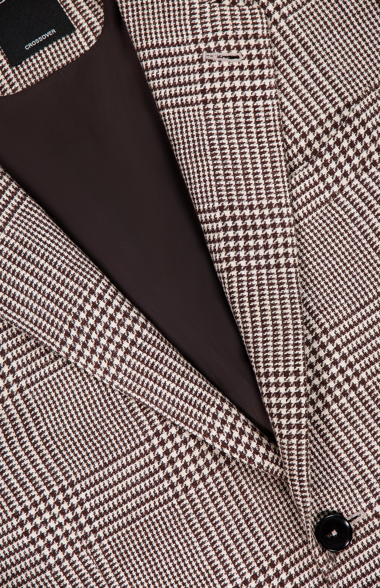 Close-up of the ZEGNA Houndstooth Plaid Linen-blend Sportcoat, showcasing brown and white checks, a black button, and dark brown lining—perfect for a men’s professional wardrobe. The garment label appears at the top.