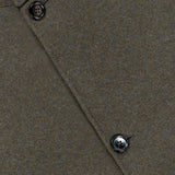 Close-up of the ZEGNA Jerseywear Chore Jacket in brown, showcasing four dark buttons and a subtly angled silhouette. The partially visible fabric label appears at the top left corner. The jacket is crafted from textured, soft material with precise stitching—capturing the refined essence of a classic wool cashmere design.