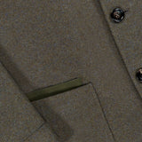 Close-up of the ZEGNA Jerseywear Chore Jacket in olive green wool-cashmere, highlighting a button, part of a flap pocket, and a neatly finished pocket edge with visible stitching. Inspired by the timeless Zegna 232 road, this piece merges classic tailoring with contemporary style.