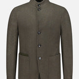 The ZEGNA Jerseywear Chore Jacket is crafted in olive green wool and features a stand collar, button-up front, and two spacious front pockets—one accented with a contrasting fabric trim. Reminiscent of a refined dark green chore jacket, this piece blends utilitarian design with elevated tailoring. The Jerseywear Chore Jacket is presented against a plain white background.