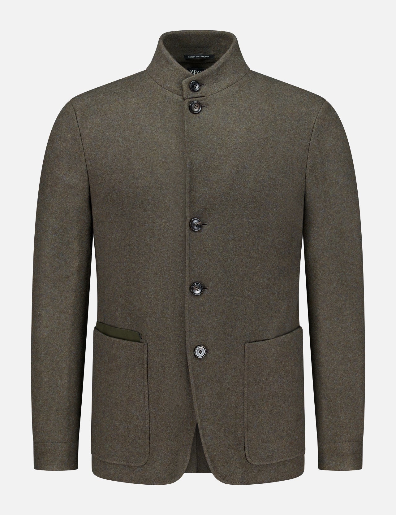 The ZEGNA Jerseywear Chore Jacket is crafted in olive green wool and features a stand collar, button-up front, and two spacious front pockets—one accented with a contrasting fabric trim. Reminiscent of a refined dark green chore jacket, this piece blends utilitarian design with elevated tailoring. The Jerseywear Chore Jacket is presented against a plain white background.