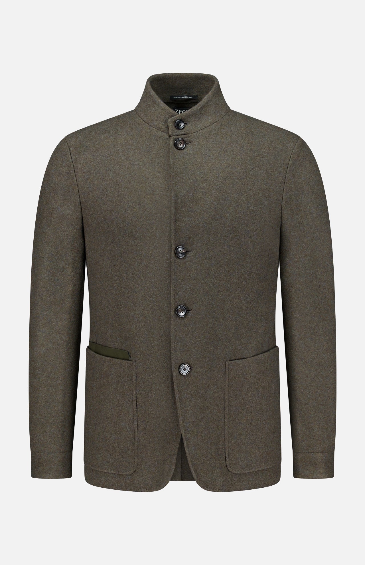 The ZEGNA Jerseywear Chore Jacket is crafted in olive green wool and features a stand collar, button-up front, and two spacious front pockets—one accented with a contrasting fabric trim. Reminiscent of a refined dark green chore jacket, this piece blends utilitarian design with elevated tailoring. The Jerseywear Chore Jacket is presented against a plain white background.