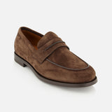 The Mocassin Loafer with Band by ZEGNA is crafted from brown Italian suede and features a low heel, rounded toe, and subtle stitching details. This men’s loafer is designed with a signature penny strap across the upper and a dark sole, shown against a plain white background.