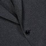 Close-up of the Oasi Cashmere Beaver Jacket by ZEGNA, a dark gray wool coat featuring two black buttons and a folded lapel. This piece embodies the refined elegance of luxury menswear, capturing the meticulous craftsmanship of Italian-made design.