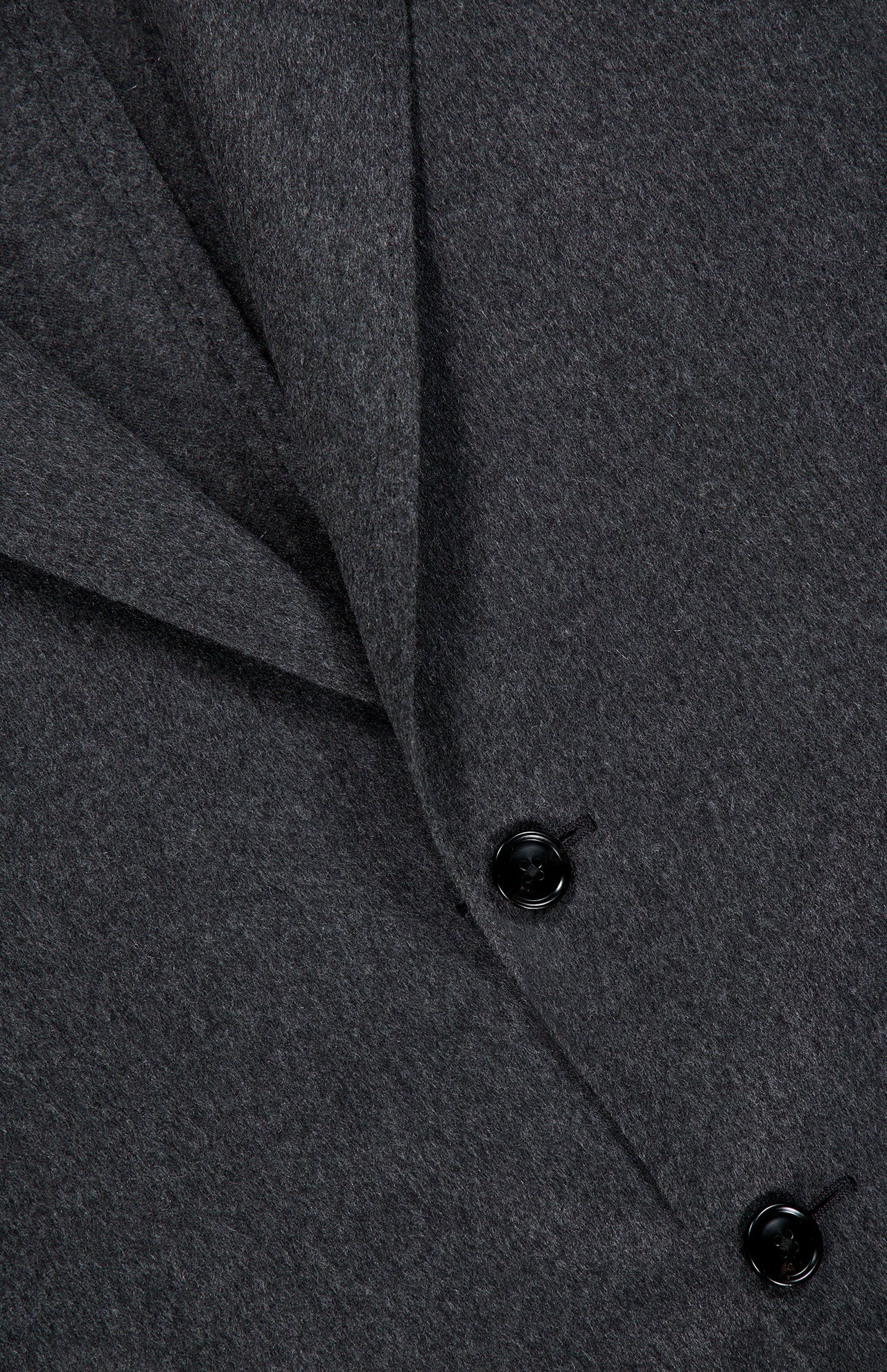 Close-up of the Oasi Cashmere Beaver Jacket by ZEGNA, a dark gray wool coat featuring two black buttons and a folded lapel. This piece embodies the refined elegance of luxury menswear, capturing the meticulous craftsmanship of Italian-made design.